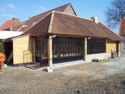 Poolhouse met stalen schrijnwerk, zowel opendraaiend als volledig openschuivend op rail met dubbel glas en mastiek look afwerking. 7. Poolhouse met stalen schrijnwerk